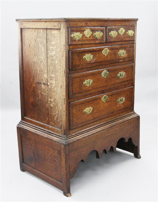 A George II featherbanded oak chest on stand, W.2ft 11in. D.1ft 11in. H.3ft 11in.